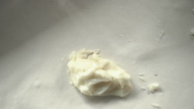 Skilled hands shaping layered dough for authentic laccha paratha preparation.
