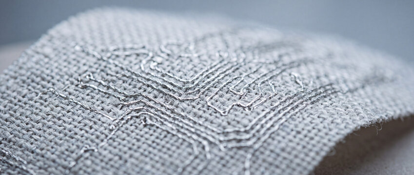 Silver thread embroidery on natural linen fabric with geometric stitch detail macro texture background for craft and textile design
