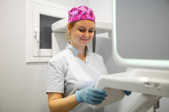 Friendly dentist working in a modern dental clinic