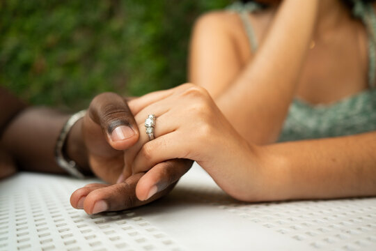 Closeup of Venezuelan and Dominican couple holding hands