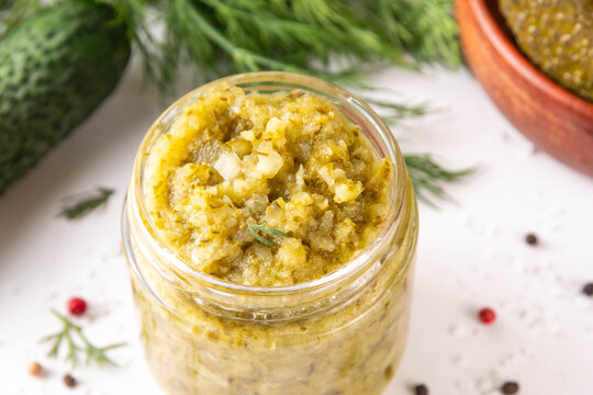 Homemade Dill Pickle Relish, tasty cucumber pickle relish condiment, with fresh cucumbers, pickles, dill, onions and spices copy space
