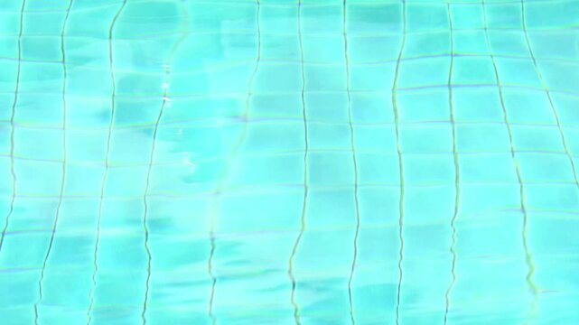 Abstract view of bottom caustics of swimming pool with ripple and flow on water surface. Swimming pool designed to hold water for leisure activities.