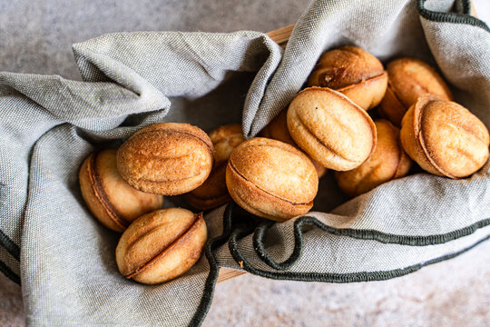 Homemade nut cookie in rustic cloth on wooden tray