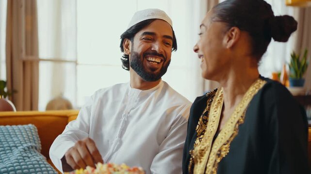 Happy beautiful young arab couple with emirati clothing together at home