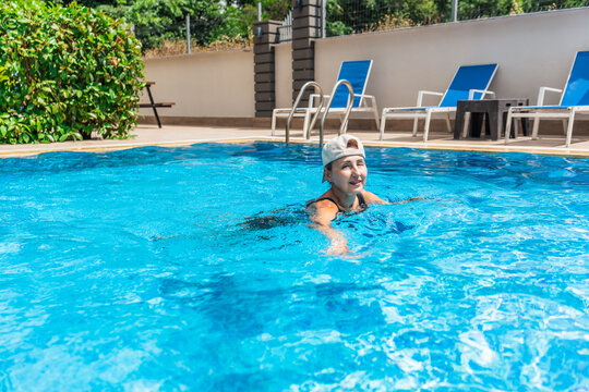 Woman enjoying a refreshing swim in blue pool