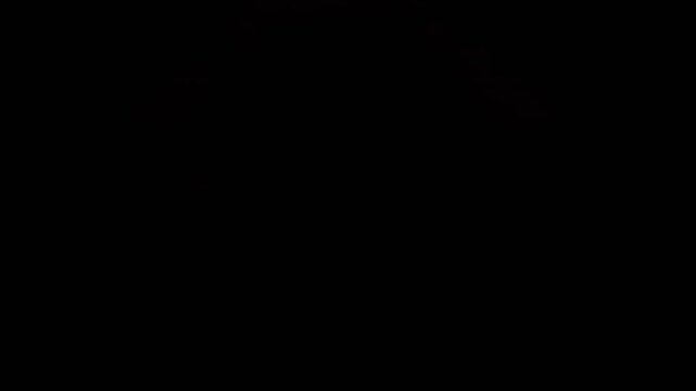A diffuse fire eruption from below slowly fades and dissolves around a granite rock in 1000fps slow motion. Long duration combustion creates a hazy atmosphere in mirrors. Concept: slow burn, dissipate