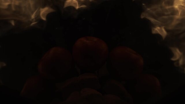A majestic swirling fire cap descends from above, gently stroking a red apple in 1000fps slow motion. A powerful luminous flash creates a radiant halo effect within the mirrored wedge perspective