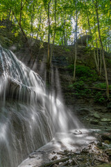 Beautiful Sherman Falls cascades gracefully amid lush greenery in Hamilton, Ontario. © John