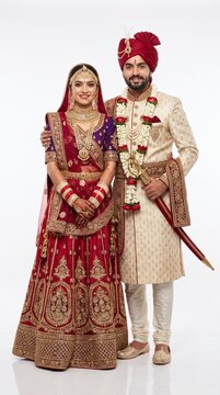 Young Rajasthani Rajput Wedding Couple in Traditional Royal Bridal Attire Isolated on White Background