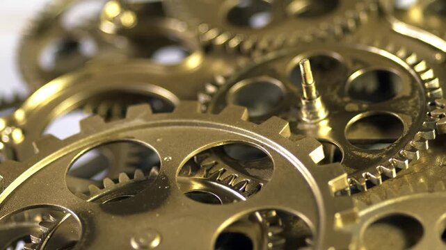 Closeup of golden clockwork gears and cogs, intricate mechanical watch movement parts