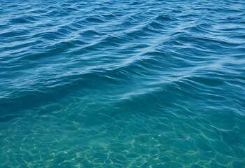 Obraz premium Blue ocean water surface with ripples and clear underwater visibility, natural marine background texture