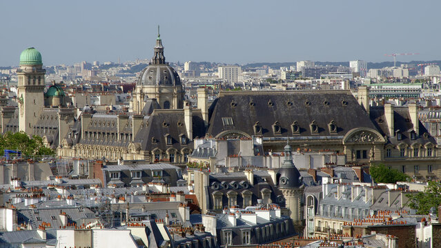 Paris skyline with the dome of Les Invalides and surrounding historic rooftops seen from above.