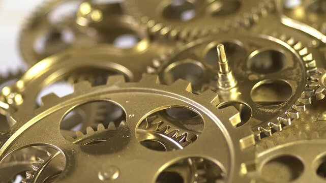 Closeup of intricate brass clockwork gears and cogs detailed view of mechanical watch movement components, highlighting the precision engineering of vintage timepieces