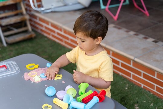 Toddler Playing With Kinetic Sand