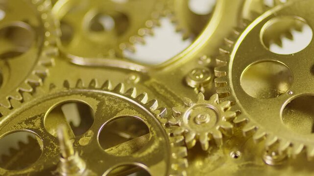 Closeup of intricate brass clockwork gears and mechanisms, showcasing mechanical precision and vintage watchmaking craftsmanship