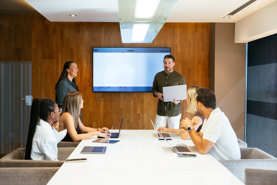 Business team presenting financial data in modern office meeting