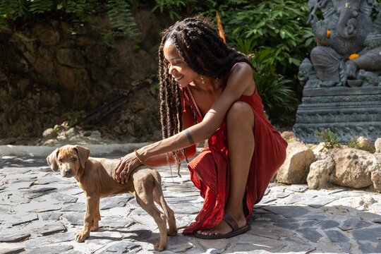 Happy Young Woman Petting Puppy, Human Animal Bonding Concept