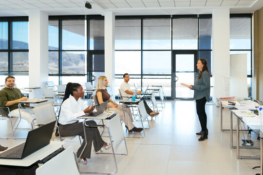 Businesswoman presenting to diverse group during corporate training