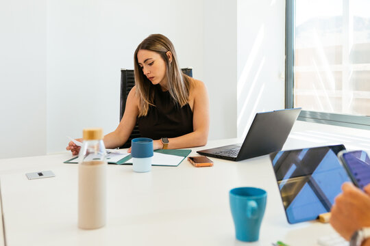 Businesswoman analyzing documents during an office meeting