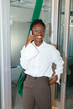 African woman entrepreneur talking on phone working