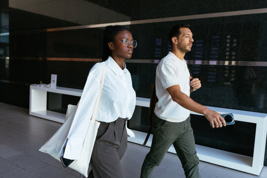 Diverse business colleagues walking in modern office building