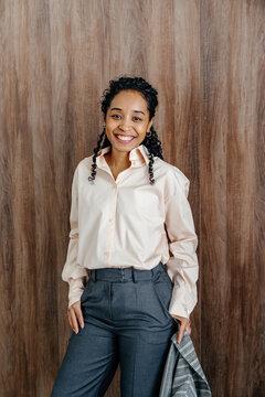 Smiling Businesswoman Holding Blazer Indoors