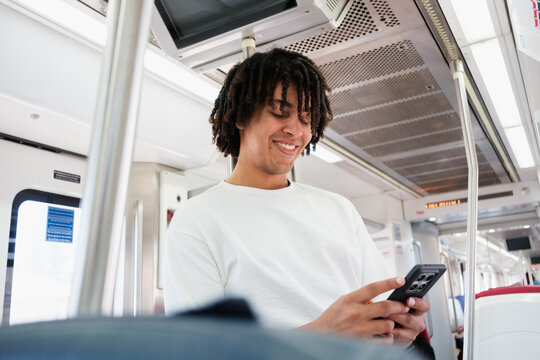 Man Using Smartphone on Public Transport During the Day
