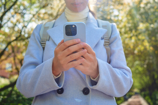Low angle of a woman using a smartphone