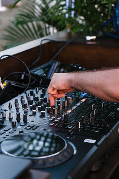 DJ at a Music Event During the Evening in an Outdoor Setting