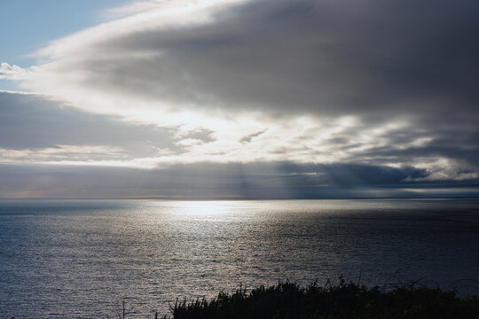 Clouds and Sunlight Over the Ocean at Sunset