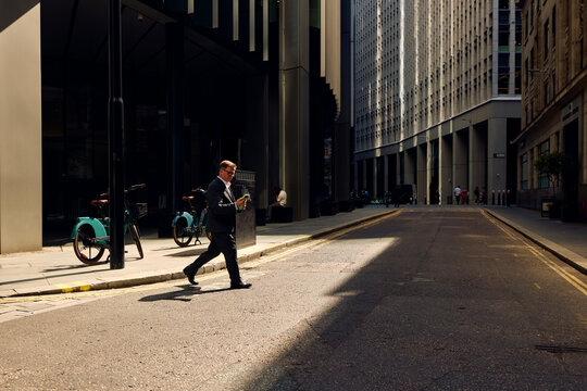 Businessman crosses the street in central London.
