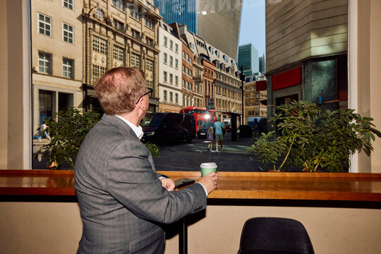 Senior businessman went out for a coffee break