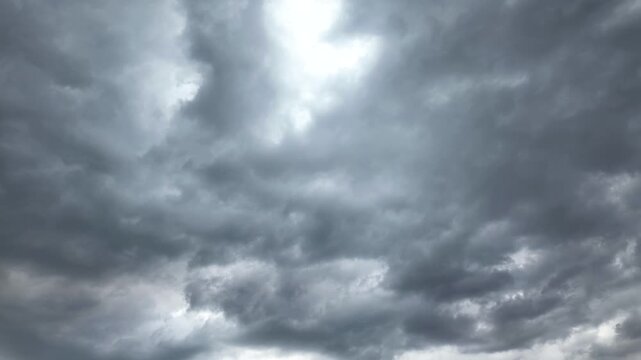 Dark clouds gather over the city in the afternoon sky. Timelapse
