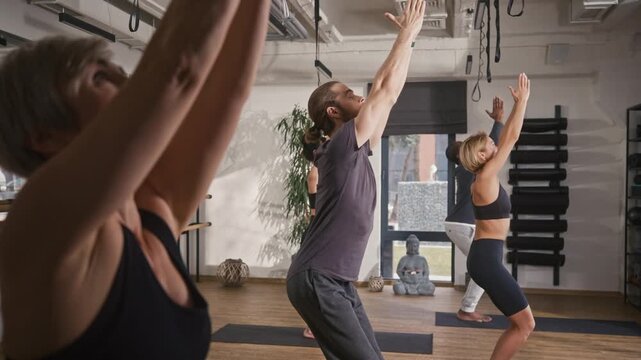 Group of people practicing hatha yoga. Man and women doing meditation pose at yoga studio. Mindfull people folding hands together at yoga session. Yogi people doing yoga asana at yoga hall.