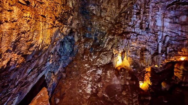 Illuminated rock formations create a dramatic scene deep within Moaning Caverns
