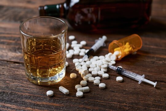 The Whiskey and Pills Scene Depicting Addiction and Risk on Wood
