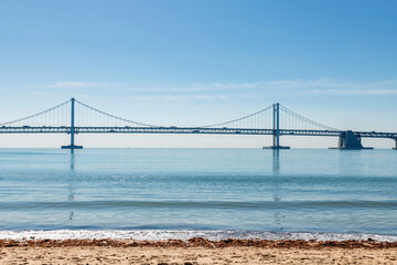 Fototapeta premium Gwangan Bridge view from Gwangalli beach with motion sea wave, Busan, South Korea. Famous travel destination in summer or spring.