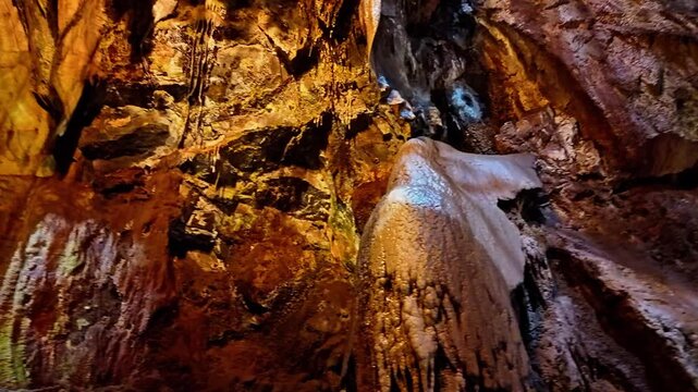 Illuminated rock formations create a dramatic scene deep within Moaning Caverns
