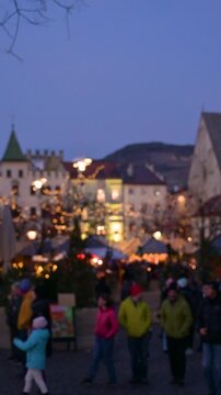 Vertical Blurred View of Christmas Market with People Walking