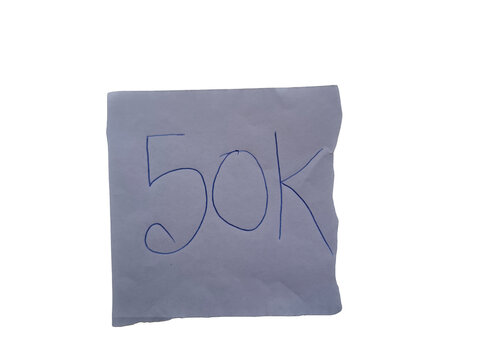 Handwritten blue ink number 50k on a white paper note with a torn edge , fifty thousand