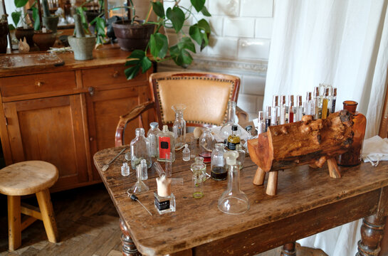 erfume bottles and glass vessels arranged on studio table in natural l