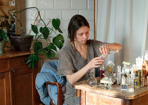 Perfumer crafting a custom fragrance in a studio workspace