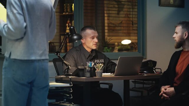 Police detective interrogating a possible male suspect at the police station