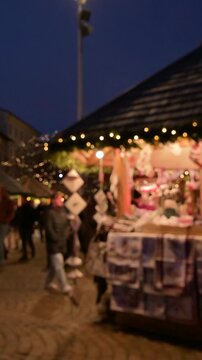 Vertical Blurred View of Christmas Market with People Walking