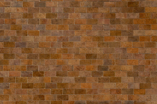 Aged sandstone brick wall with handmade bricks. Multi-colored brown and ochre masonry surface for a vintage background.
