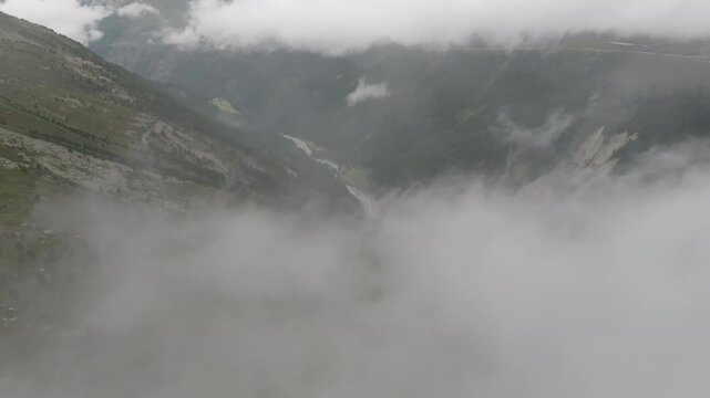 Beautiful aerial landscape of the Tyrol Alps featuring rocky mountain ridges above clouds wide green meadows pristine nature and scenic tourism destination in Europe 