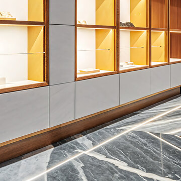 Interior display cabinets with glass shelves and marble flooring in a retail setting storefront showroom