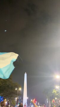 BUENOS AIRES, ARGENTINA - JULY 2026: Cinematic view of the historic soccer fan celebration at the Obelisco downtown Buenos Aires with national flags.