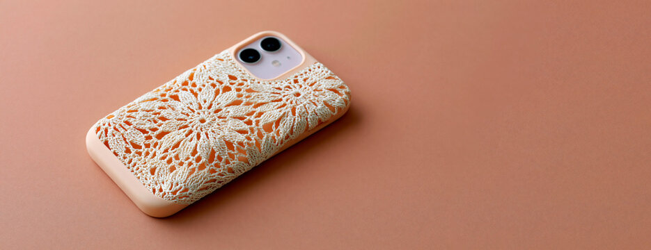 Smartphone with handcrafted lace inspired floral case on pastel background showcasing elegant accessory and minimalist design