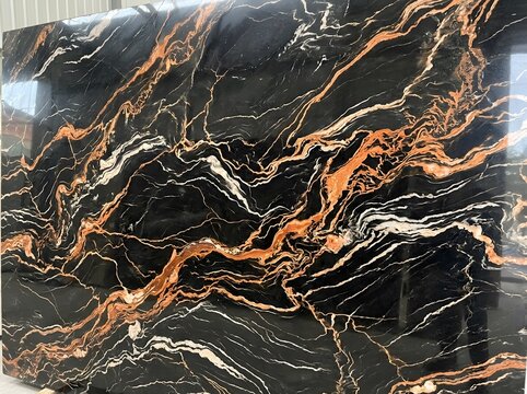 Luxury black marble slab with dramatic copper and white veining patterns